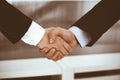 Businessman and woman shaking hands in office. Concept of handshake as success symbol in business Royalty Free Stock Photo