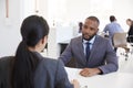 Businessman and woman sitting at desk in an open plan office Royalty Free Stock Photo