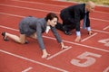 Businessman and woman on start line of running track Royalty Free Stock Photo