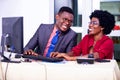 Businessman and woman working together on laptop