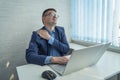 Young businessman work with computer late at night room. He tired and stressed needs rest. He has shoulder neck and back Royalty Free Stock Photo