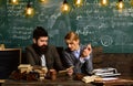 Businessman work with woman secretary in school office. Bearded man and sensual woman read book. Couple with typewriter Royalty Free Stock Photo