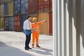 Businessman and worker with cargo containers