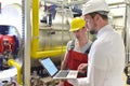 Businessman and worker meeting in a factory - maintenance and repair of the industrial plant