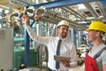 Businessman and worker meeting in a factory - maintenance and repair of the industrial plant Royalty Free Stock Photo