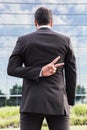 Businessman or worker in suit shows peace sign near office building Royalty Free Stock Photo