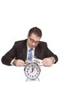 Businessman working with an alarm clock