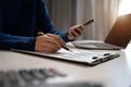 Businessman working on calculator to calculate financial data report, accountancy document and laptop computer at office, business Royalty Free Stock Photo