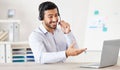 Businessman working in a call center. Customer service agent talking to a customer. Sales rep wearing a headset using a Royalty Free Stock Photo