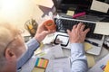 Businessman working on a cluttered and messy desk, light effect Royalty Free Stock Photo