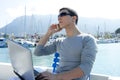 Businessman working with computer on a boat Royalty Free Stock Photo