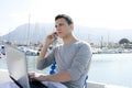 Businessman working with computer on a boat Royalty Free Stock Photo