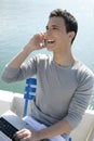 Businessman working with computer on a boat Royalty Free Stock Photo