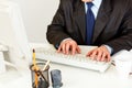 Businessman working on computer. Closeup on hands.