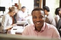 Businessman Working At Desk With Meeting In Background Royalty Free Stock Photo