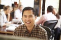 Businessman Working At Desk With Meeting In Background Royalty Free Stock Photo