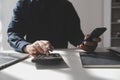 businessman working on desk office with using a calculator to calculate the numbers, finance accounting concept Royalty Free Stock Photo