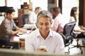 Businessman Working At Desk Using Mobile Phone Royalty Free Stock Photo