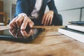 Businessman working with digital tablet and laptop with financial business strategy at a workplace