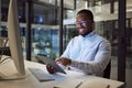 Businessman working on digital tablet late in office at night, happy and inspired by career goal. Motivation, management Royalty Free Stock Photo