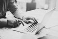 Businessman working with generic design notebook. Holding smartphone in hands. Horizontal, sunlight effects, black white Royalty Free Stock Photo