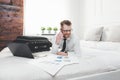 Businessman working from a hotel room with his mobile phone Royalty Free Stock Photo