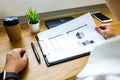 Businessman working with income statement document on the wood t Royalty Free Stock Photo