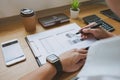 Businessman working with income statement document on the wood t Royalty Free Stock Photo