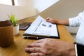 Businessman working with income statement document on the wood t