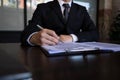 Businessman working with income statement document on the wood table.Business concept Royalty Free Stock Photo