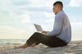 Businessman working with laptop on beach. Business trip Royalty Free Stock Photo