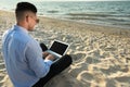 Businessman working with laptop on beach. Business trip Royalty Free Stock Photo