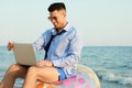 Happy businessman working with laptop on beach. Business trip Royalty Free Stock Photo