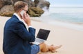 Businessman working on the beach