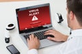 Businessman Using Laptop With Virus Alert On Screen Royalty Free Stock Photo