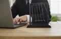 Businessman working on laptop computer at his office desk with Newton's pendulum Royalty Free Stock Photo