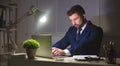 Businessman working on laptop in dark office