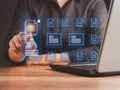 Businessman working at a laptop and digital documents with checkbox lists on virtual screen. Online documentation database and