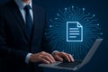 Businessman working on a laptop with a glowing digital document icon and circuit board background symbolizing data management and Royalty Free Stock Photo