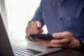 Businessman working on laptop and holding smartphone. Modern workspace for office work and communication Royalty Free Stock Photo