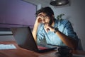 Businessman working on a laptop, overworking, under pressure