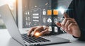 Businessman working on laptop with virtual screen showing data management and cybersecurity icons Royalty Free Stock Photo