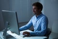 Businessman Working Late At Desk In Office Royalty Free Stock Photo