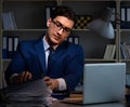 Businessman working late at night in office for overtime bonus Royalty Free Stock Photo