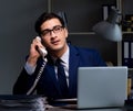 Businessman working late at night in office for overtime bonus Royalty Free Stock Photo