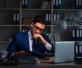 Businessman working late at night in office for overtime bonus Royalty Free Stock Photo