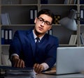 Businessman working late at night in office for overtime bonus Royalty Free Stock Photo