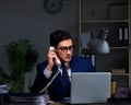 Businessman working late at night in office for overtime bonus Royalty Free Stock Photo