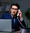 Businessman working late at night in office for overtime bonus Royalty Free Stock Photo
