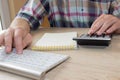 Businessman working on office desk with Calculator, a computer, a pen and document. Man, Businessman counting money and making cal Royalty Free Stock Photo